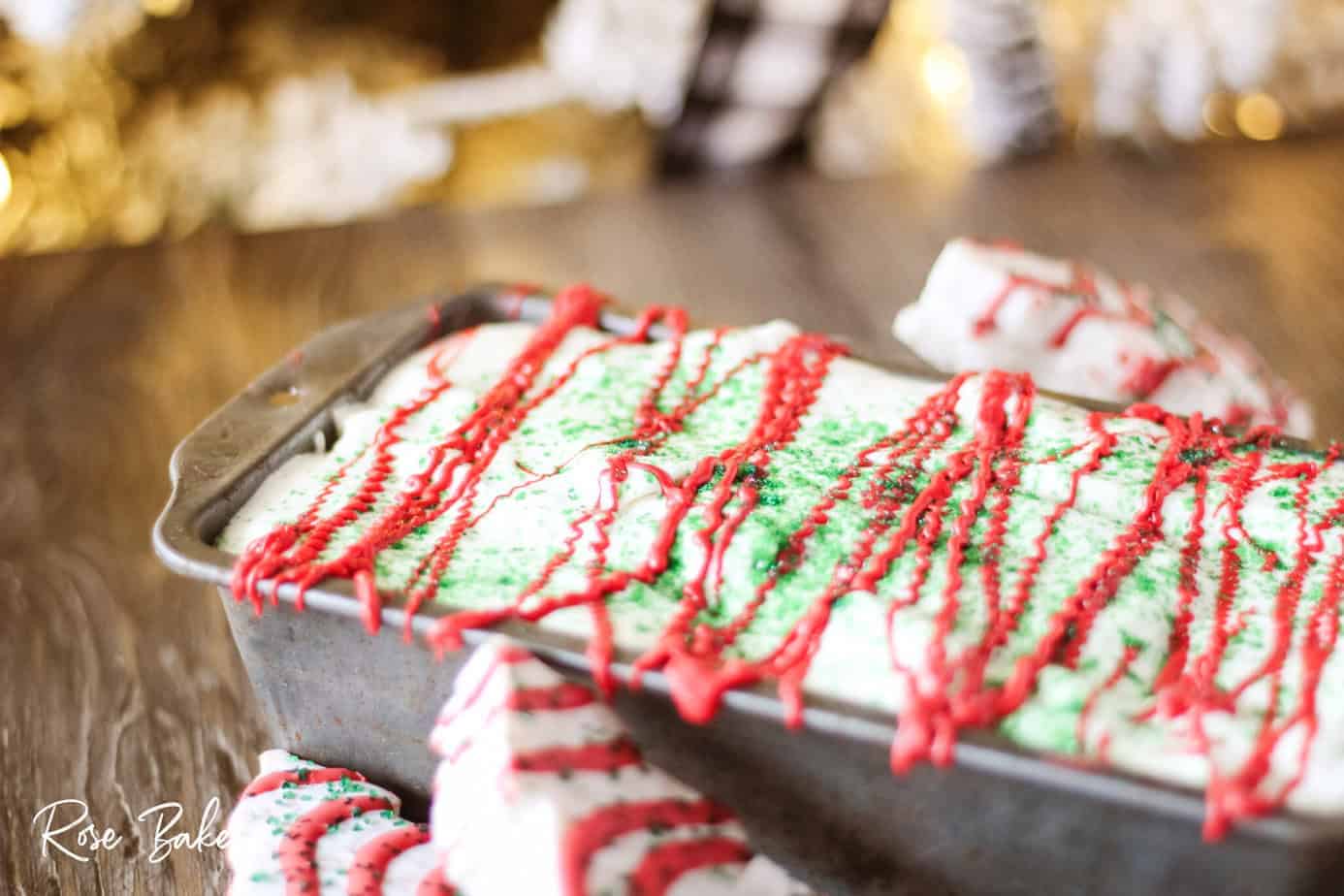 green sanding sugar sprinkled over Little Debbie Christmas Tree Cake ice cream in pan