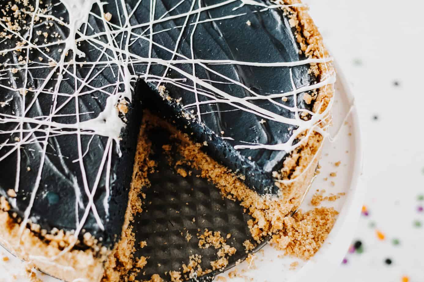 a slice missing from spinderweb cheesecake (creepy halloween dessert)