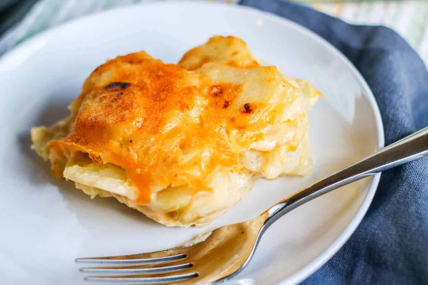 Instant Pot Au Gratin Potatoes on a white plate with a fork