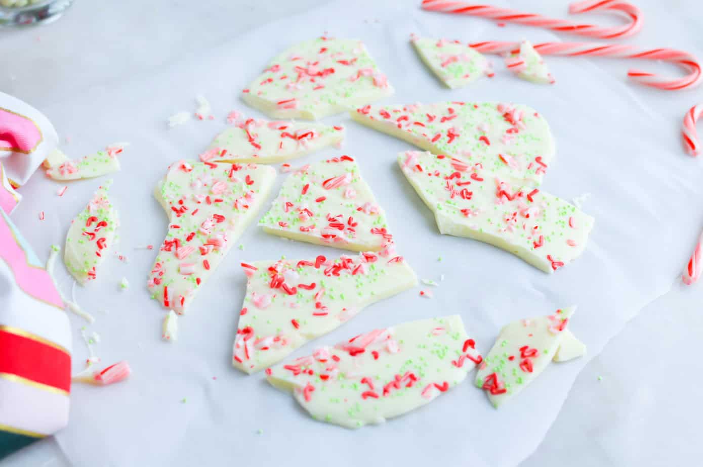broken white chocolate peppermint bark on parchmetn paper