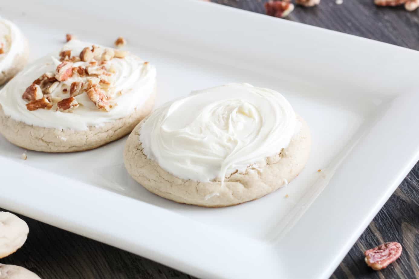 baked cookies with cream cheese frosting spread on them
