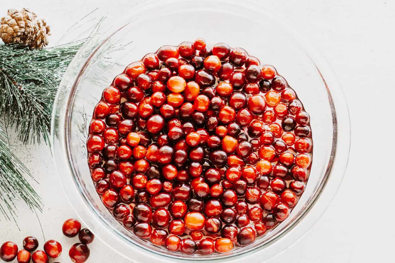 syrup coated cranberries in a glass bowl