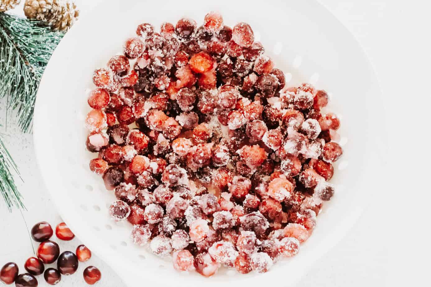 sugar coated cranberries in a strainer