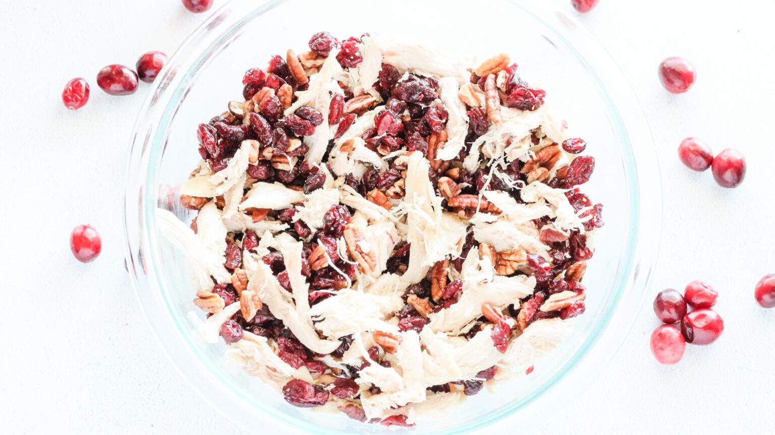 Chicken cranberries and pecans in large bowl