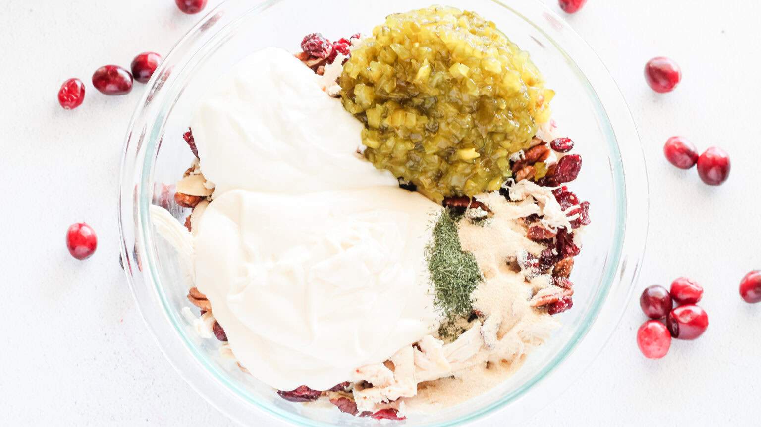 The remaining ingredients added to bowl of chicken cranberries and pecans