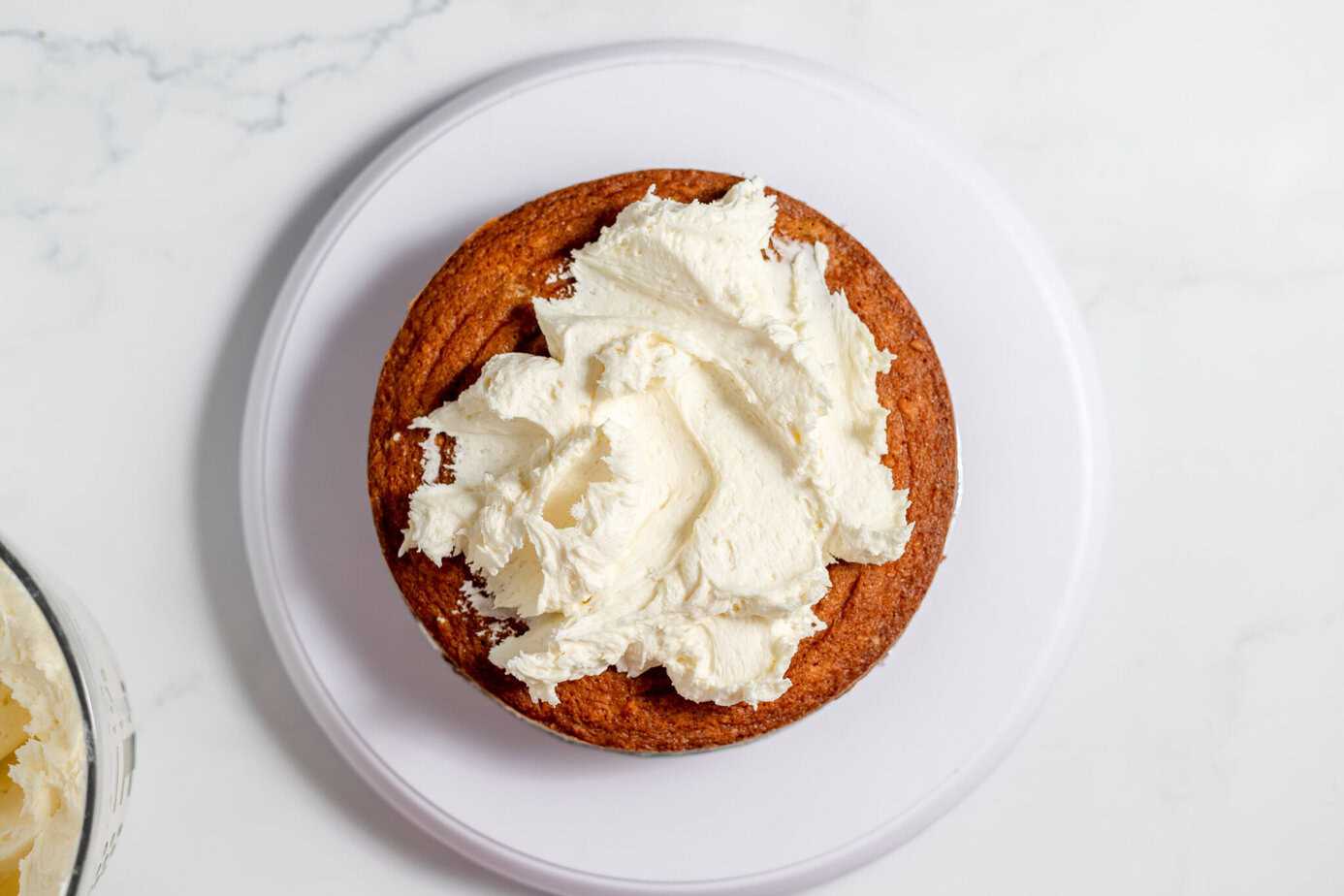 cake layer with cream cheese frosting on top