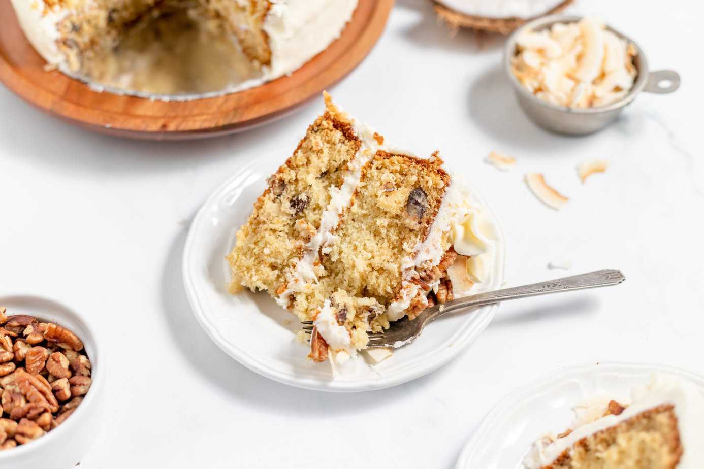 Italian Cream Cake with a slice on a plate next to the cut cake