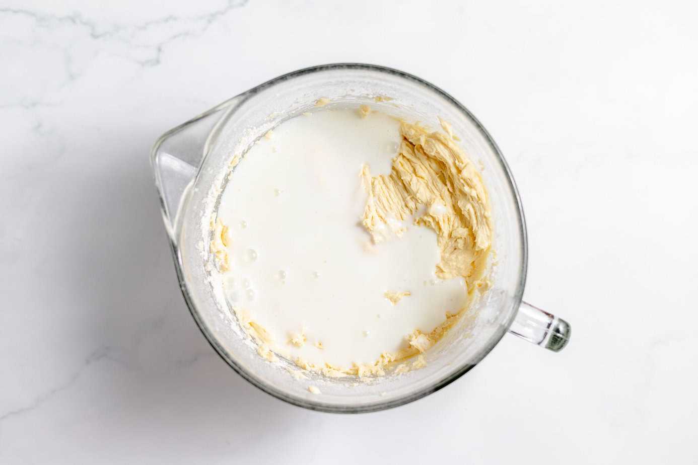 buttermilk added to mixed cake batter in clear bowl