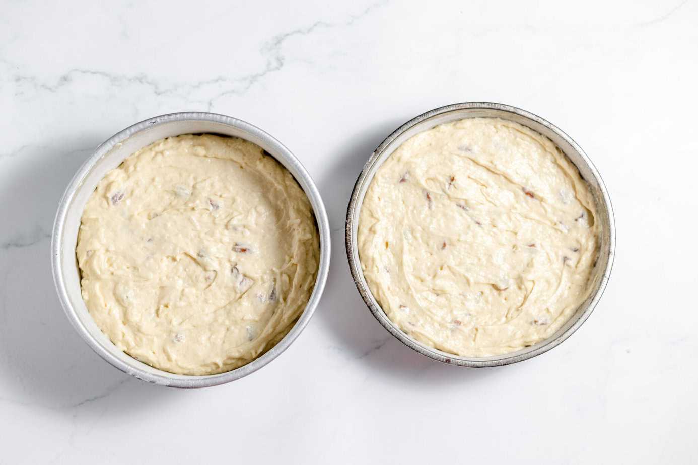 italian cream cake batter in cake pans