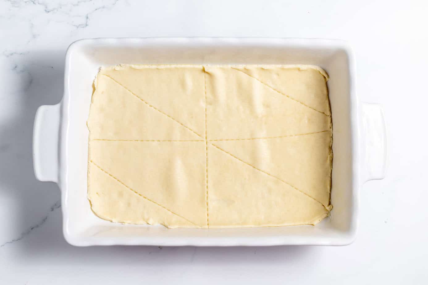 crescent roll spread in a baking pan