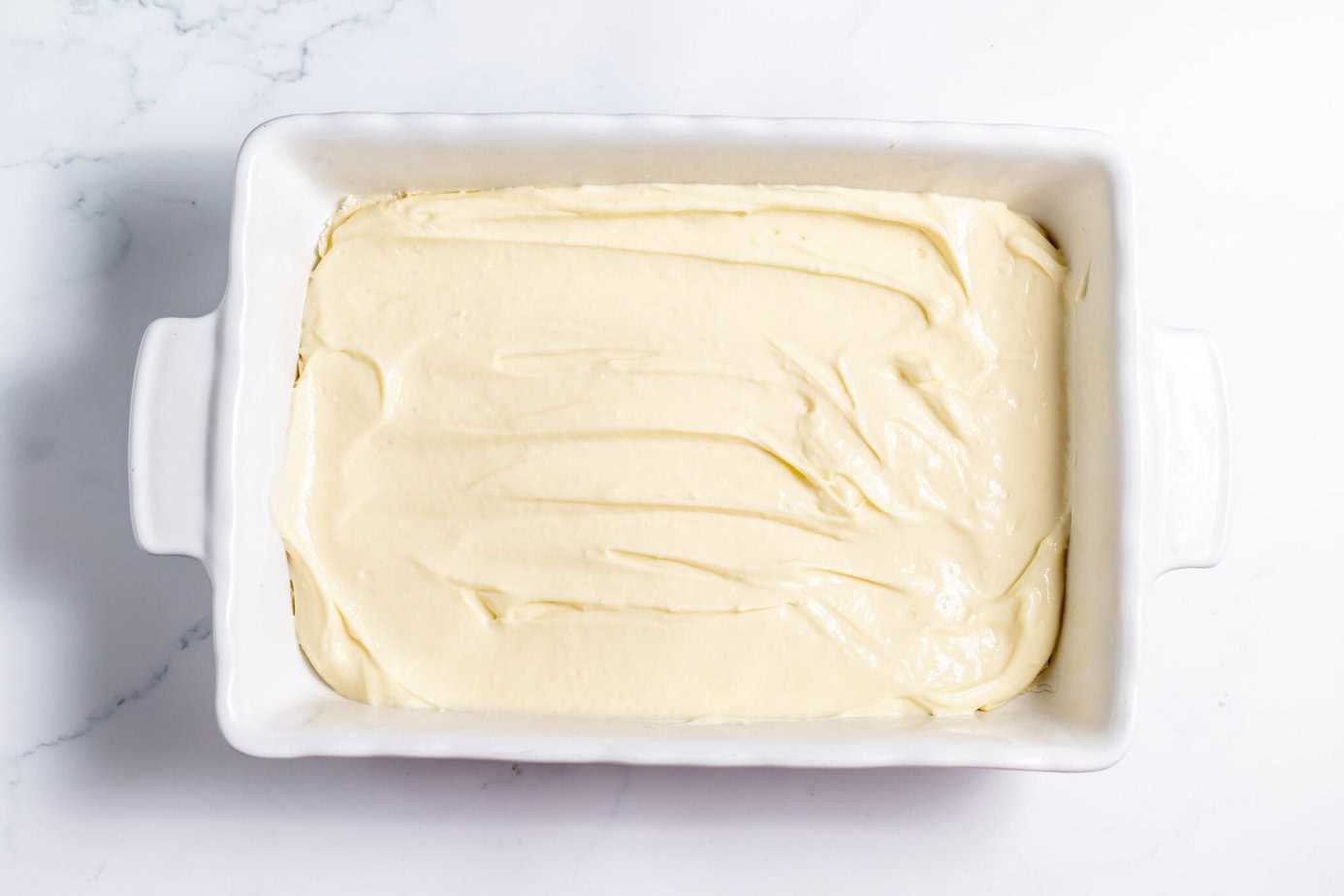 cheesecake filling spread over crescent roll