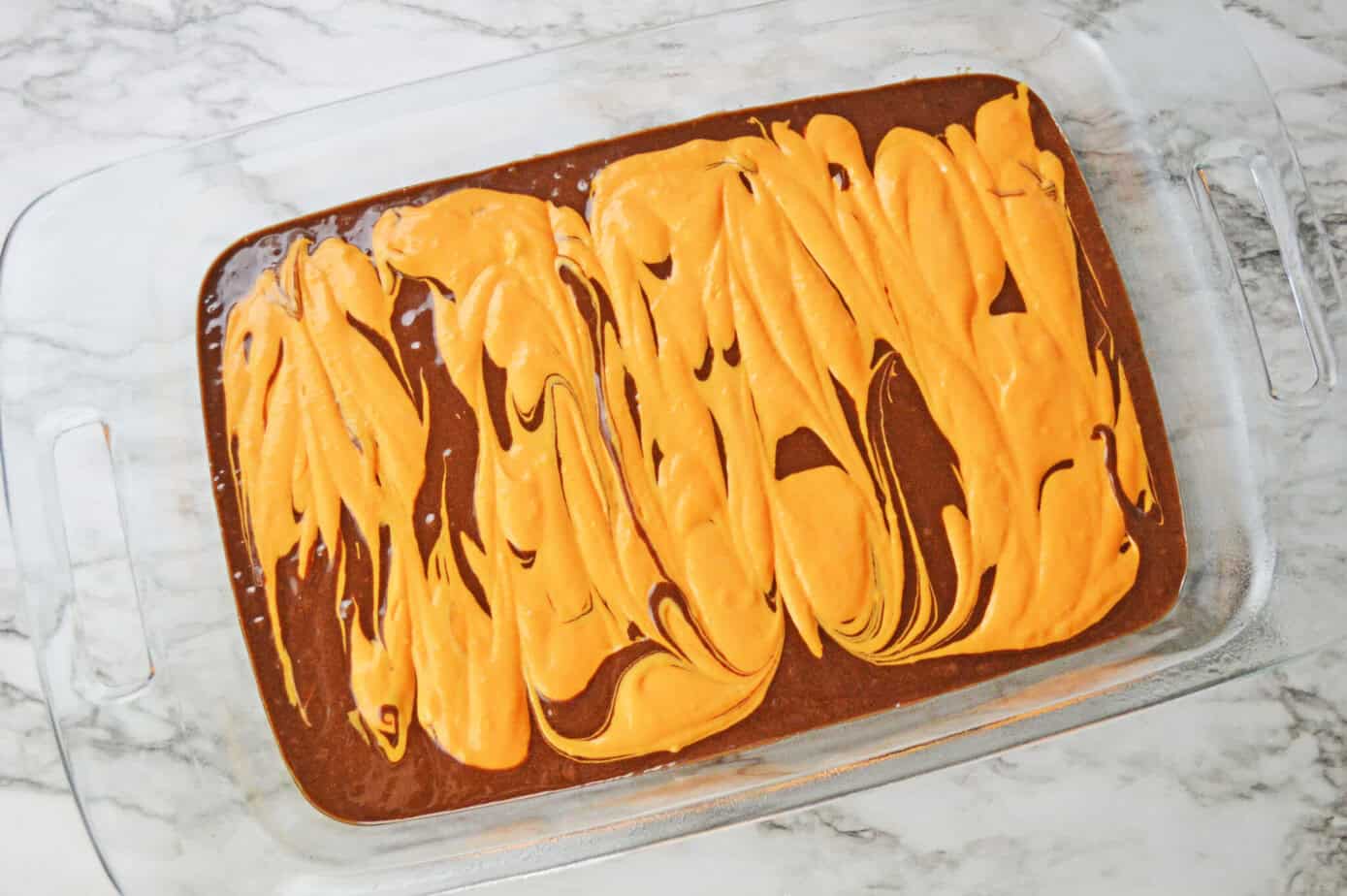 cheesecake batter swirled into brownie batter