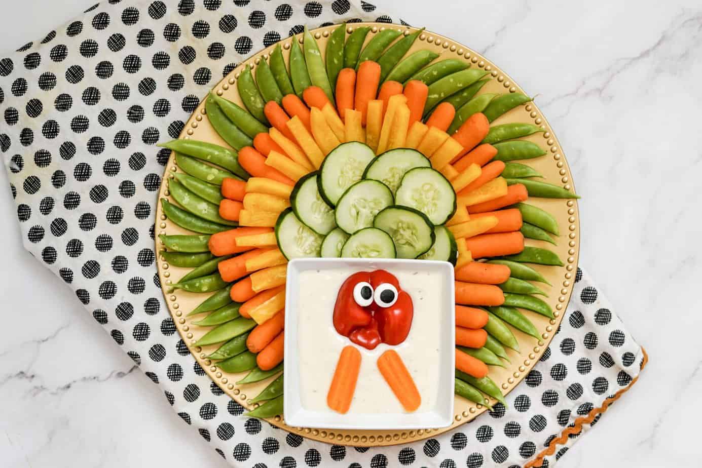 red bell pepper face and carrot sticks for th turkey bottom to finish the cute turkey veggie tray