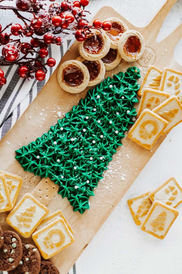 Christmas Buttercream Board in the shape of a Christmas Tree surrounded by cookies