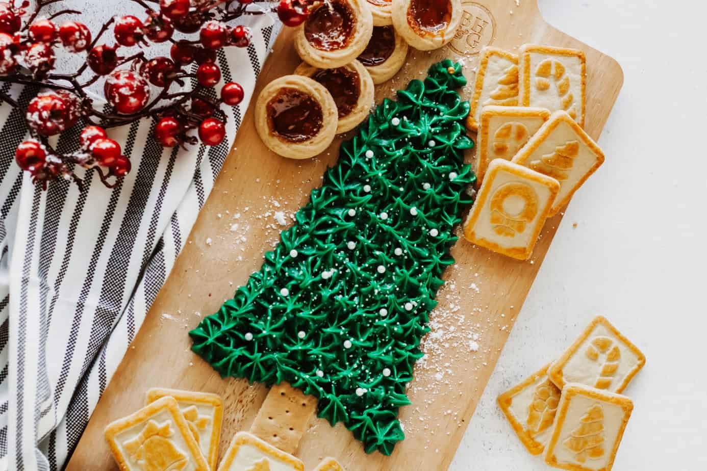 Christmas Buttercream Board in the shape of a Christmas Tree surrounded by cookies