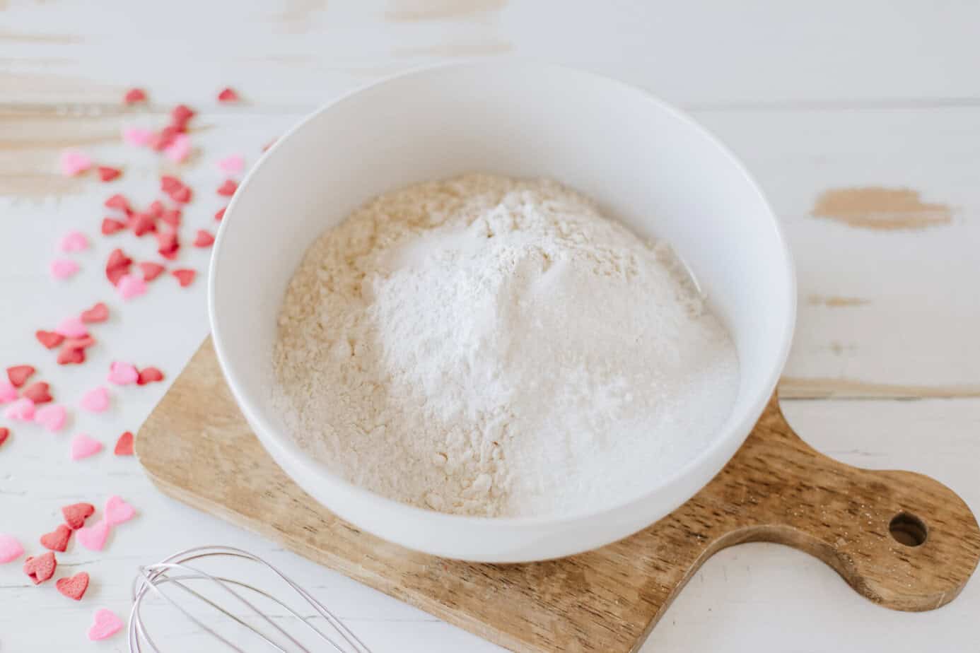 dry ingredients for strawberry pancakes in white mixing bowl