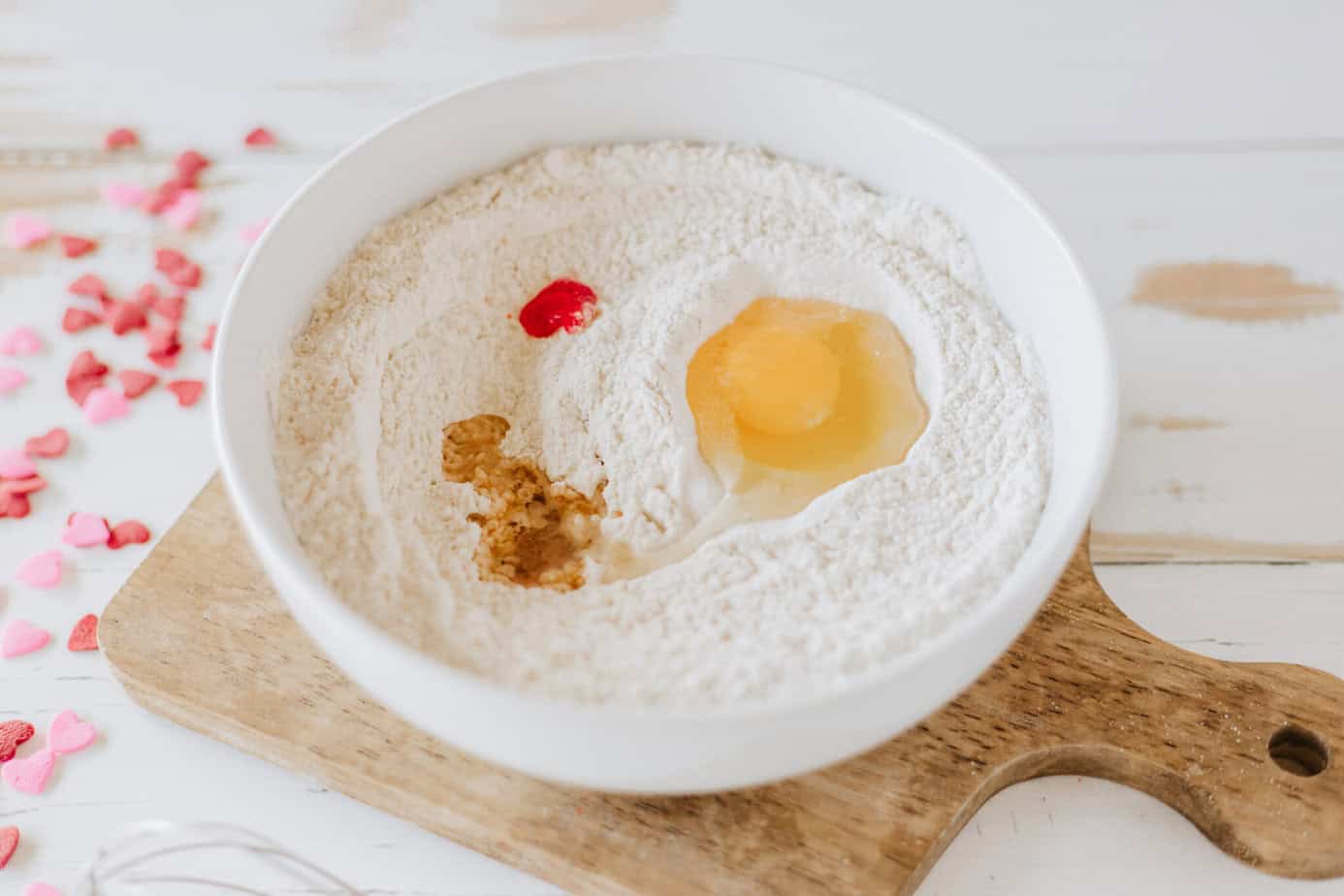 wet ingredients for strawberry pancakes added to white mixing bowl