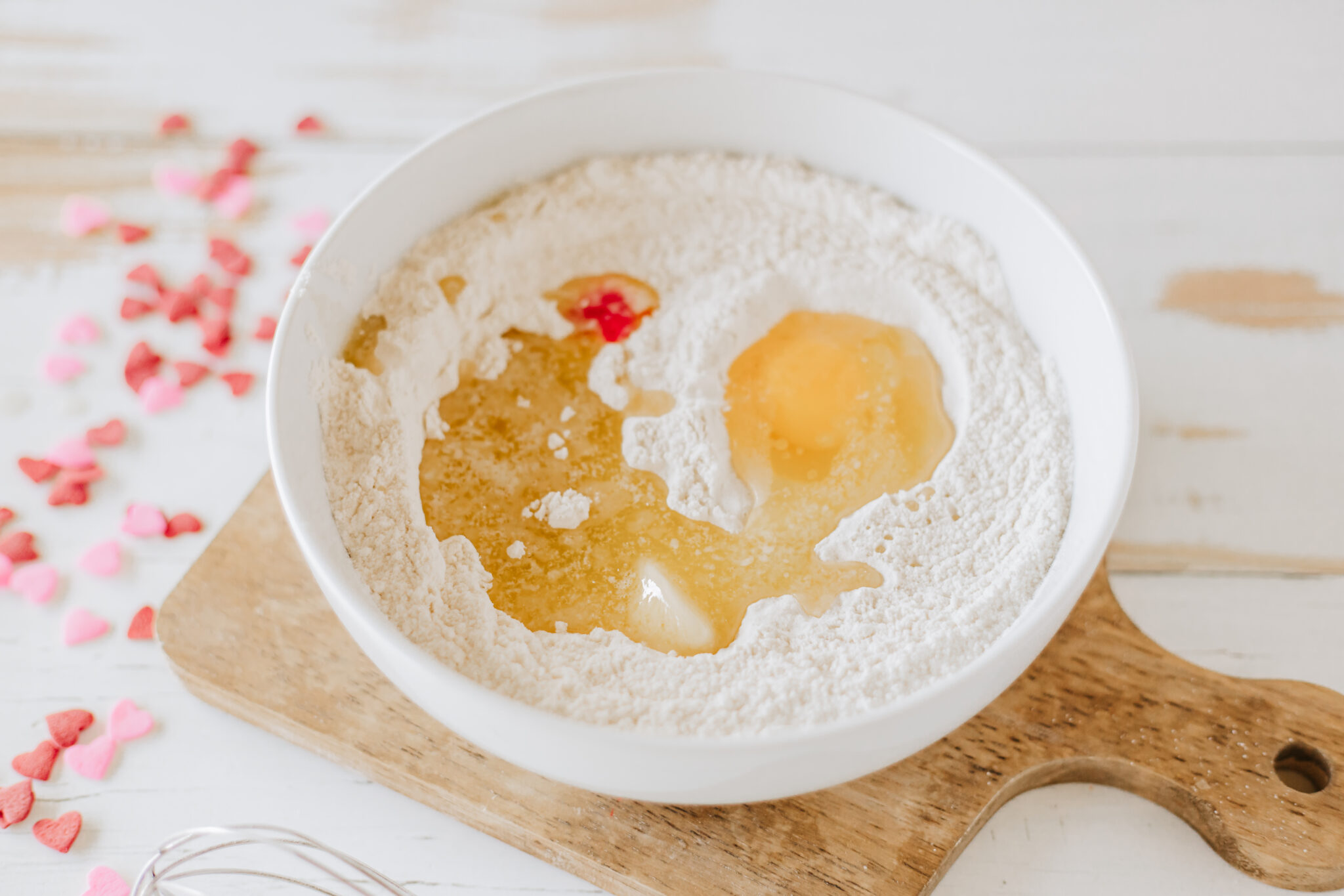 wet ingredients for strawberry pancakes added to white mixing bowl