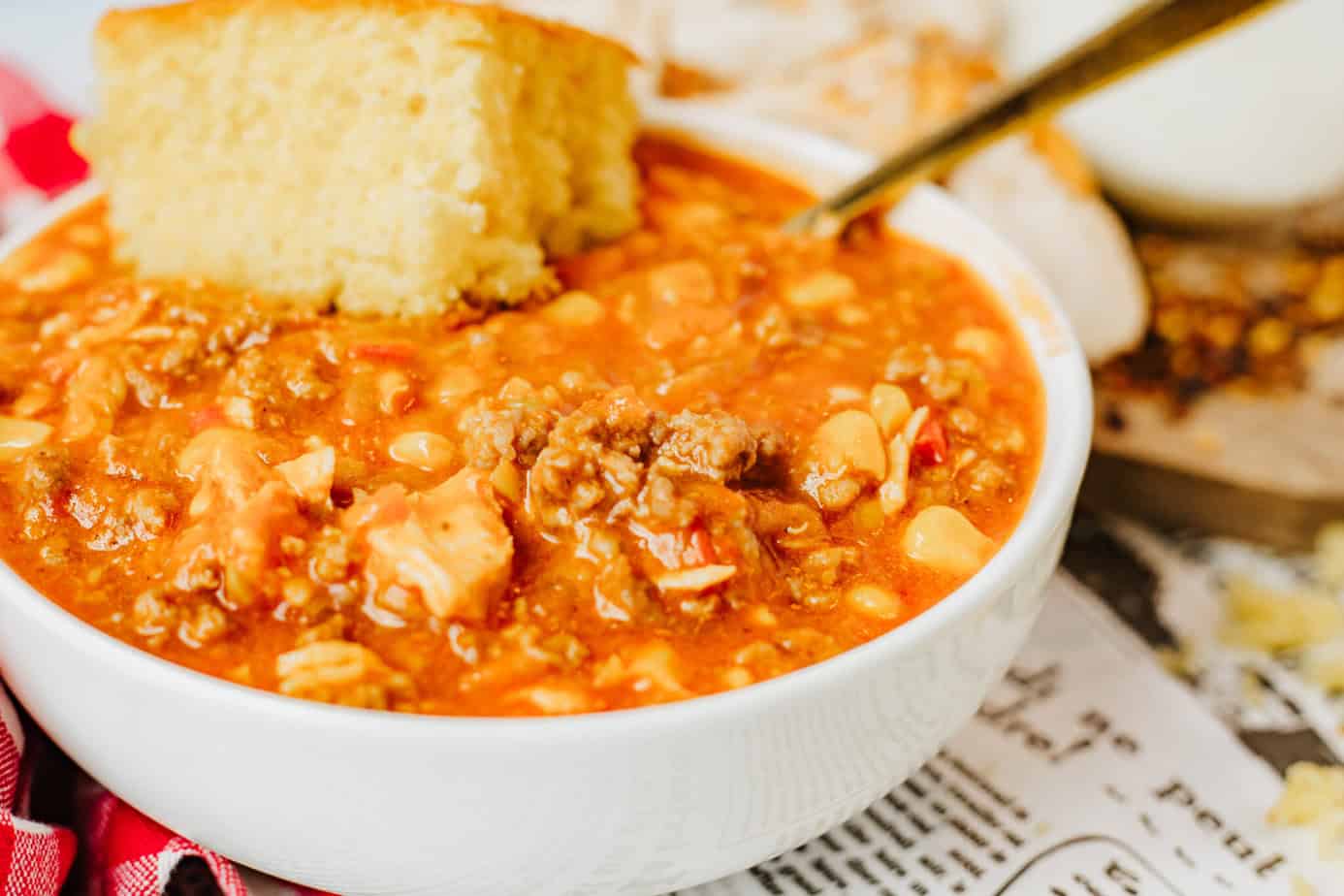 smokey bones brunswick stew in a bowl with cornbread and a spoon