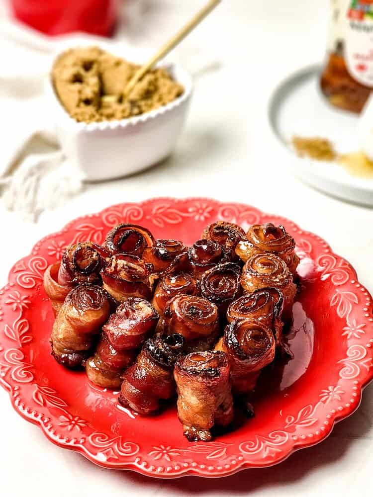 bacon roses in the shape of a heart on a red plate