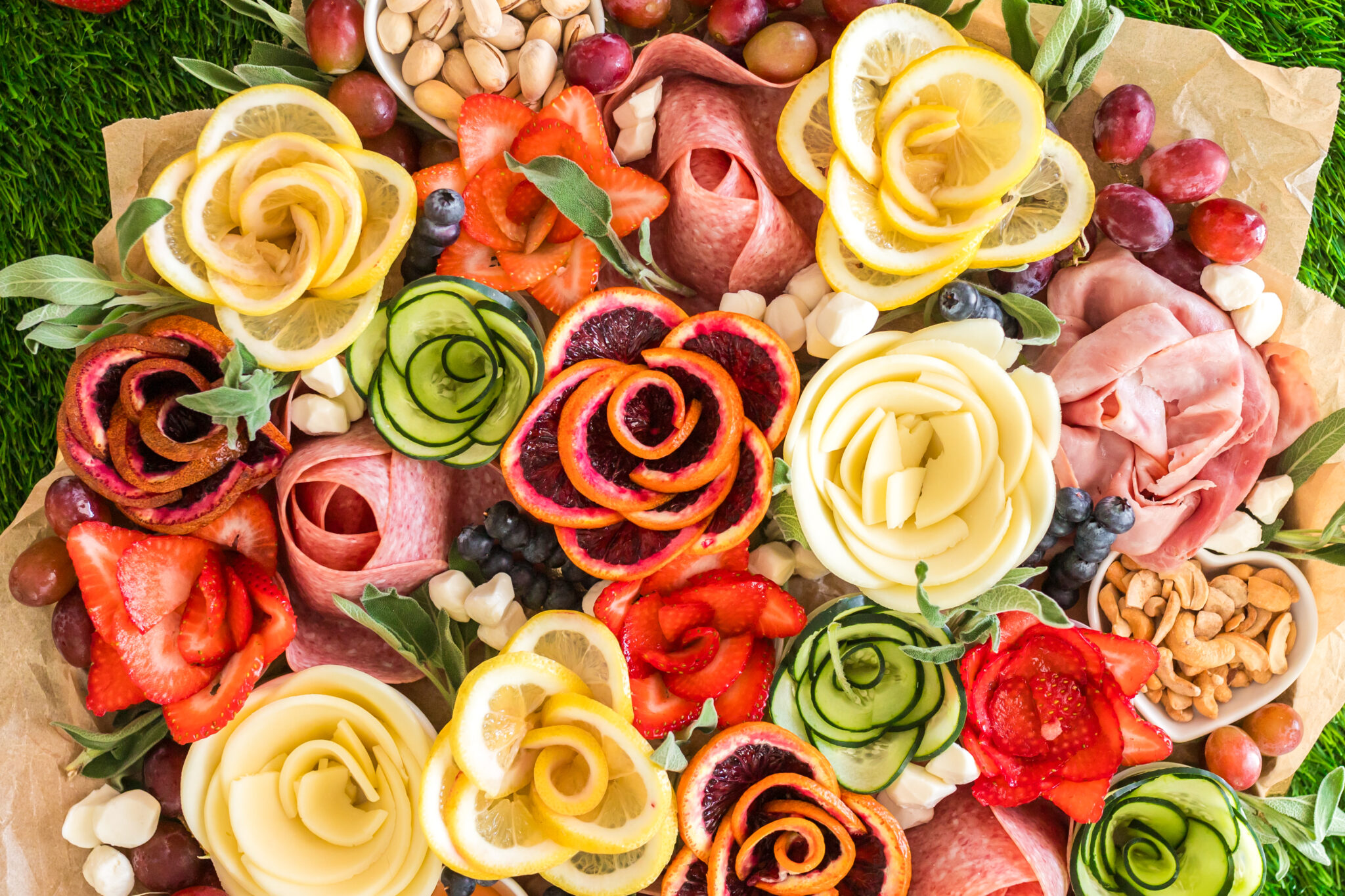 spring charcuterie board with charcuterie flowers made of meat, cheese, fruit and veggies