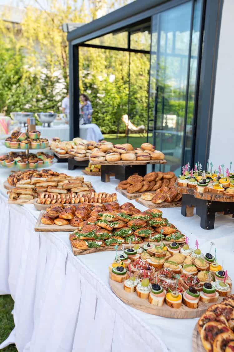 table covered with dishes and brunch foods