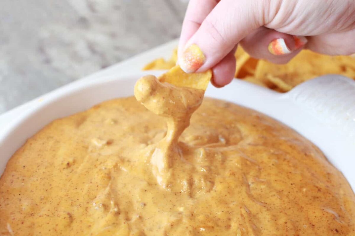 fritos scoops dipping into chili cheese dip
