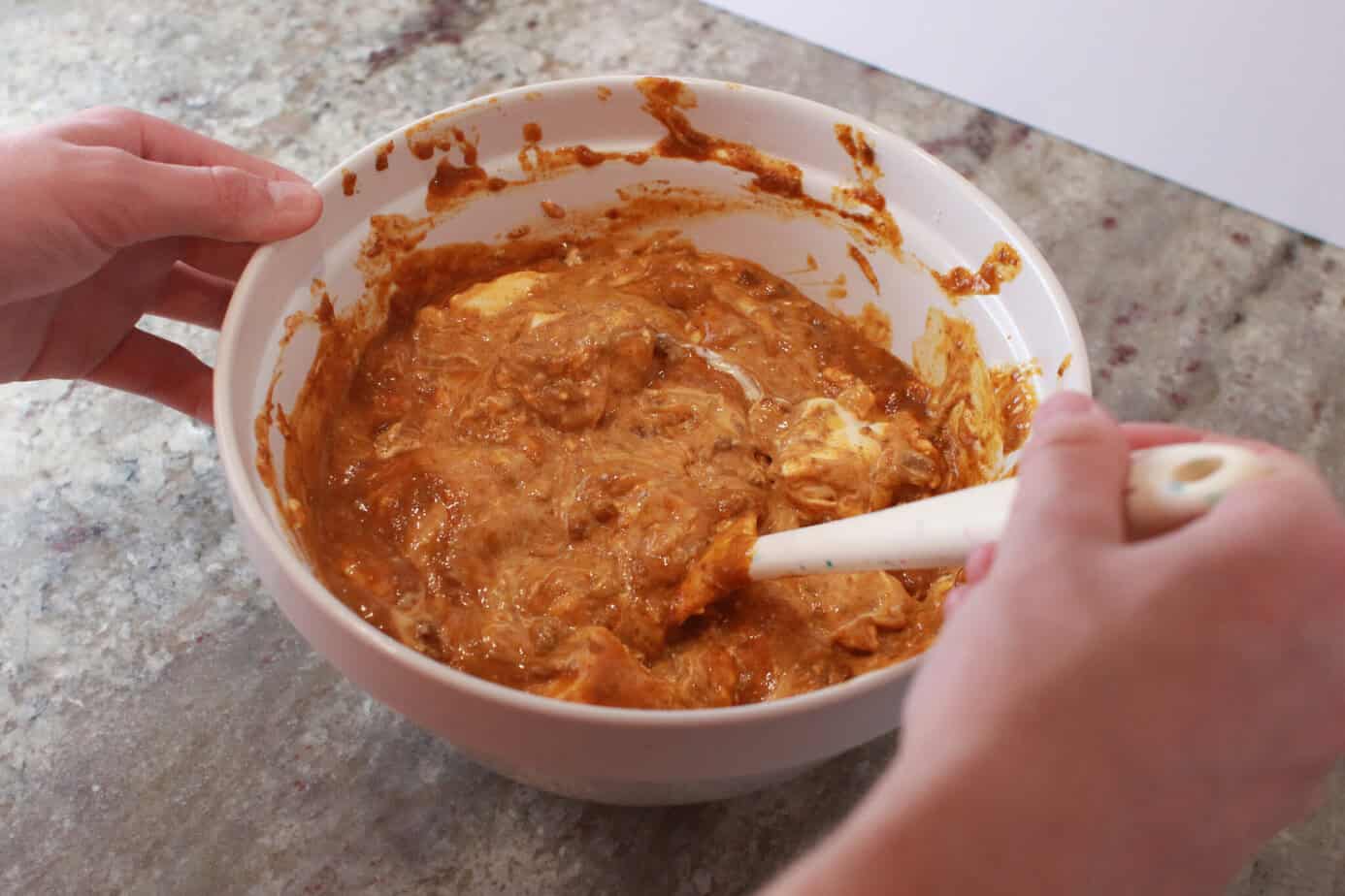 melted cheeses and chili mixed in white mixing bowl