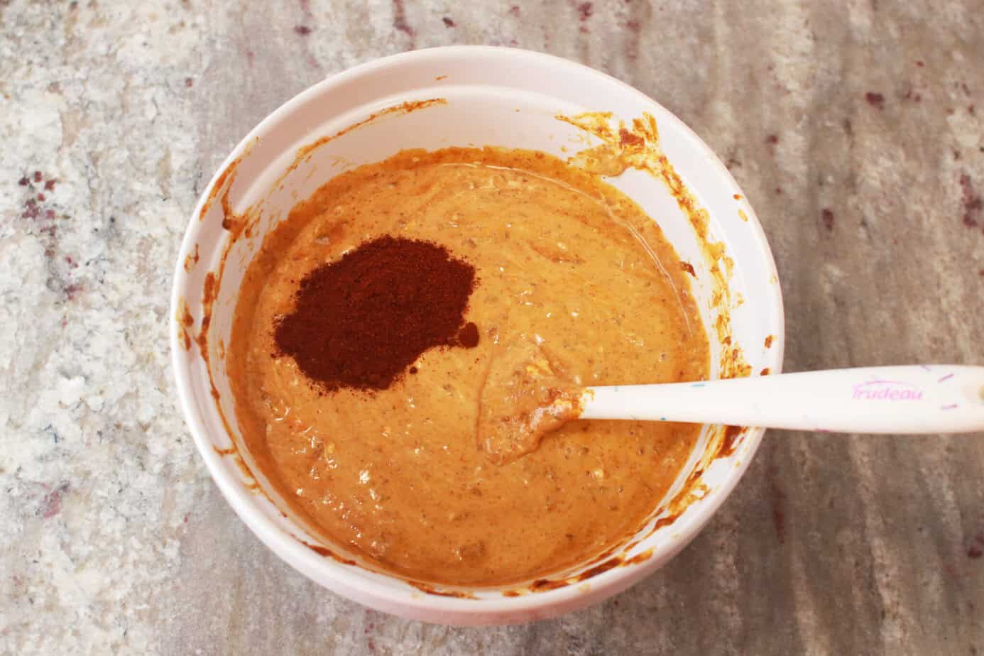 chili powder added to melted chili cheese dip