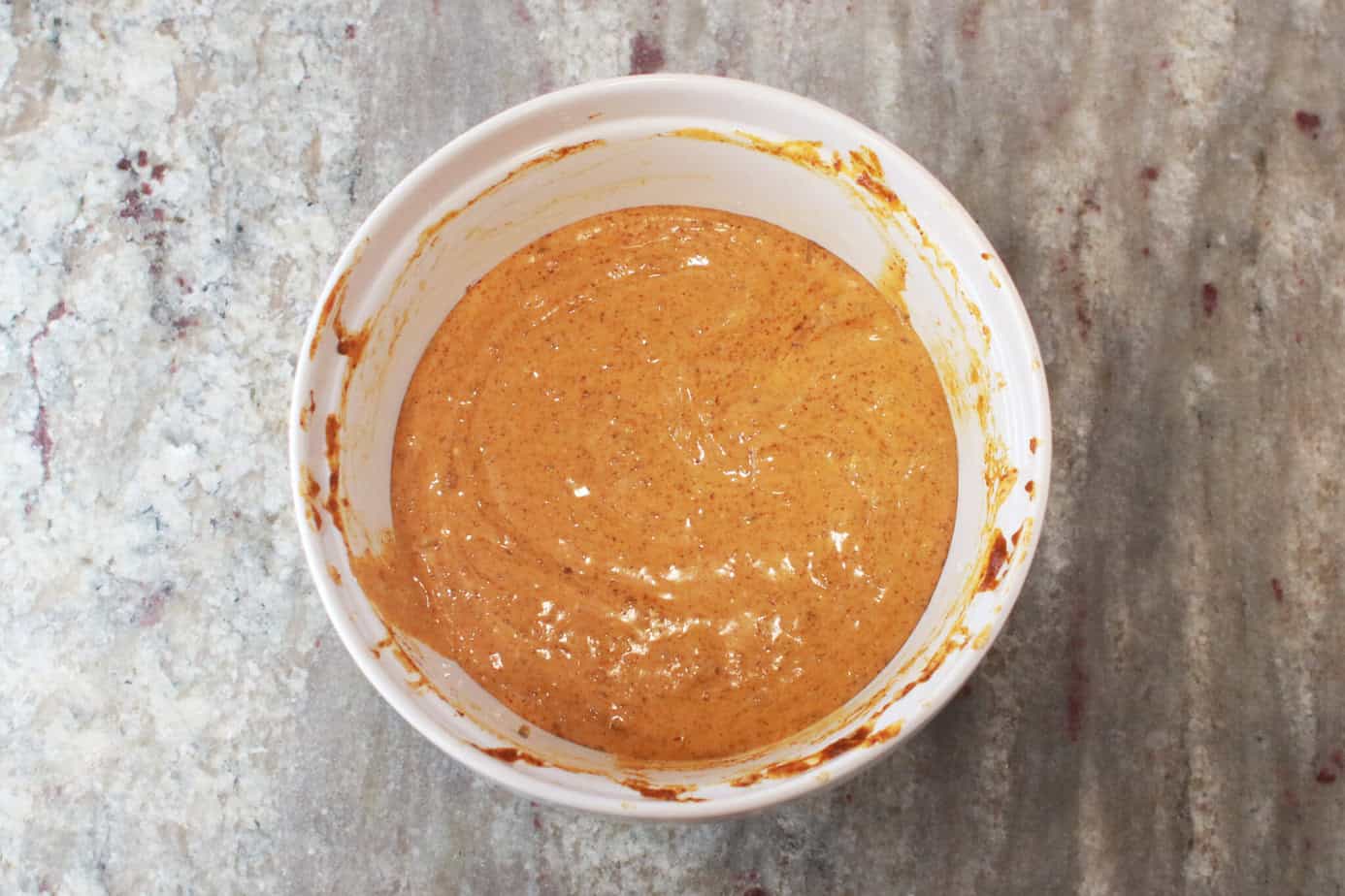 finished chili cheese dip in a white bowl