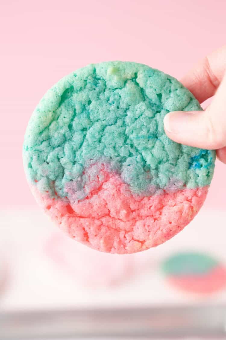 pink and blue cotton candy cookie being held