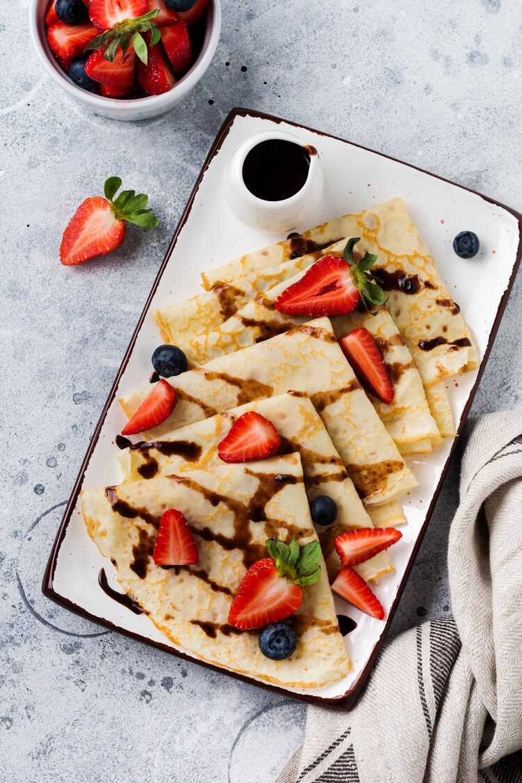 crepes on a platter with strawberries