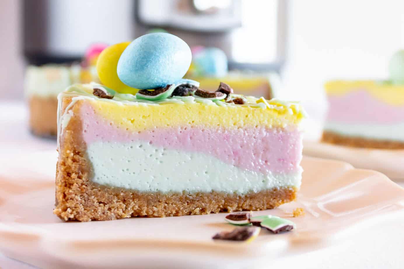 instant pot easter cheesecake with eggs on top and pastel layers inside
