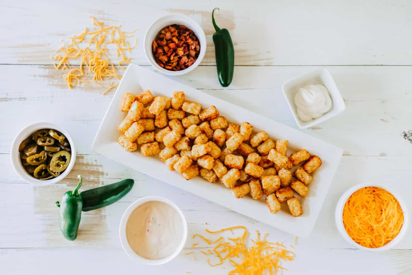 loaded tater tots ingredients on a white surface