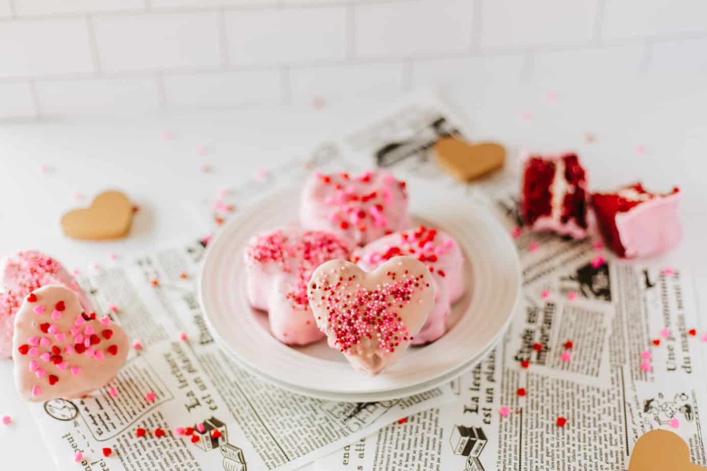 pink chocolate dipped mini heart cakes with red and pink sprinkles