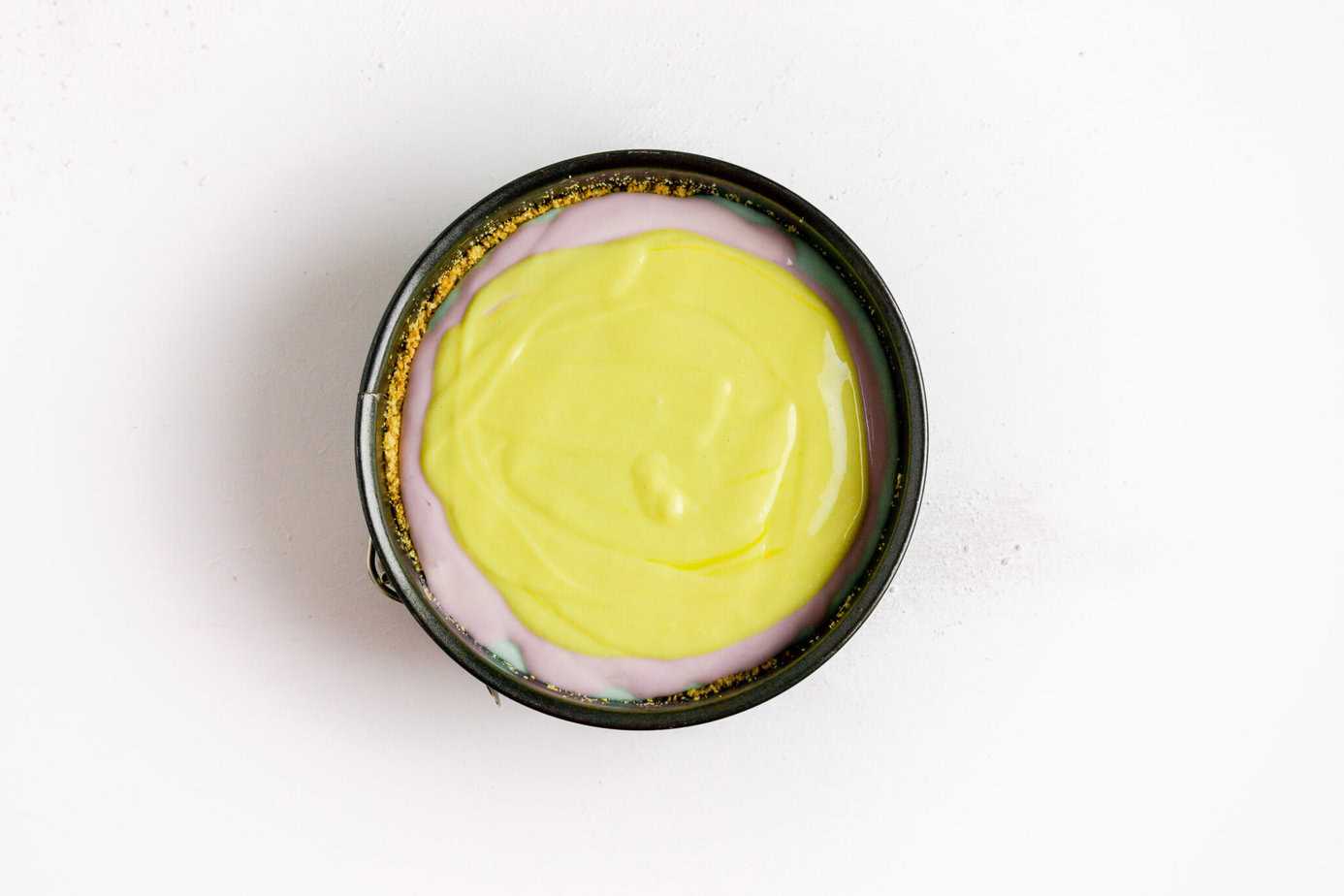 layered cheesecake batter in springform pan