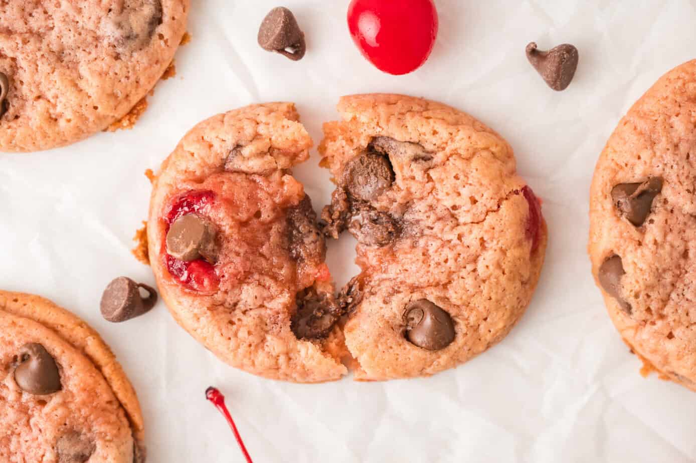 a broken cherry chocolate chip cookie laid in halves