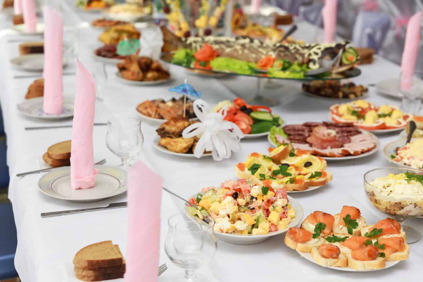 table covered with dishes and breakfast foods for brunch