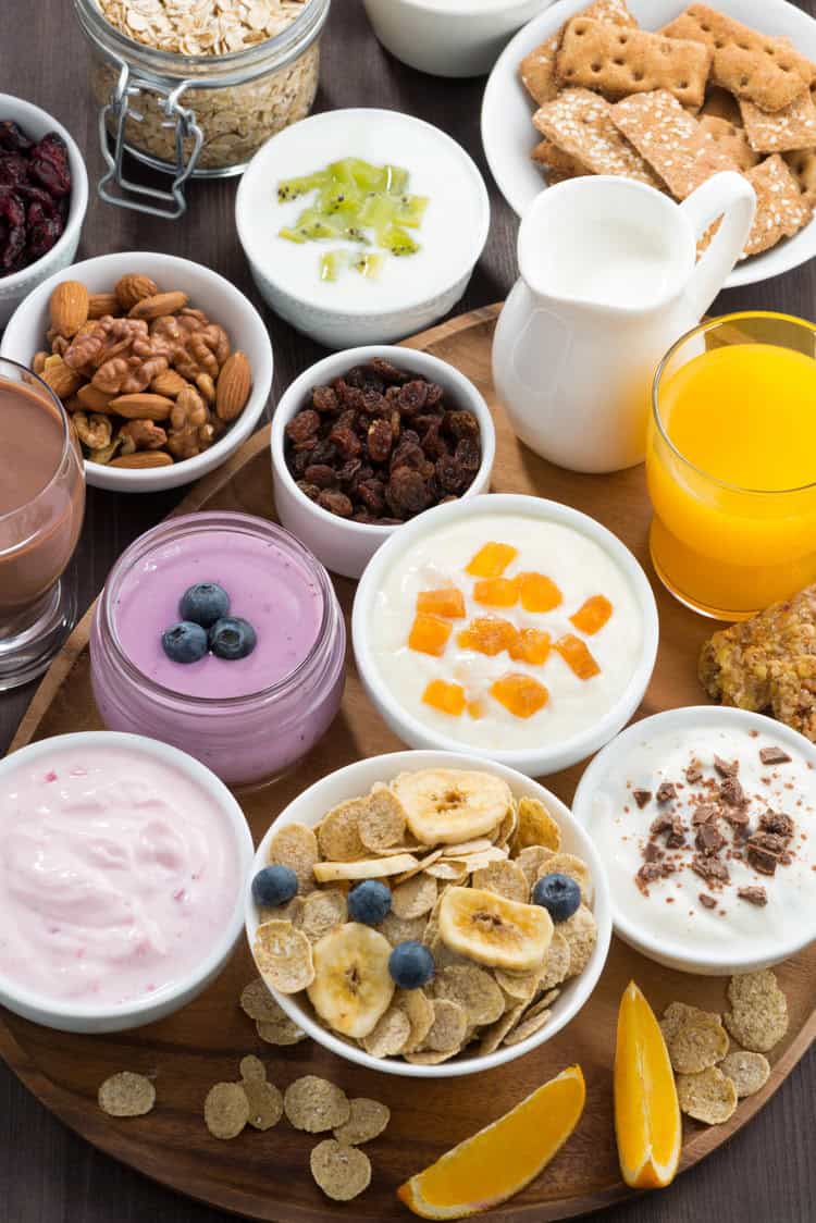yogurt with nuts and bananas and other toppings in bowls