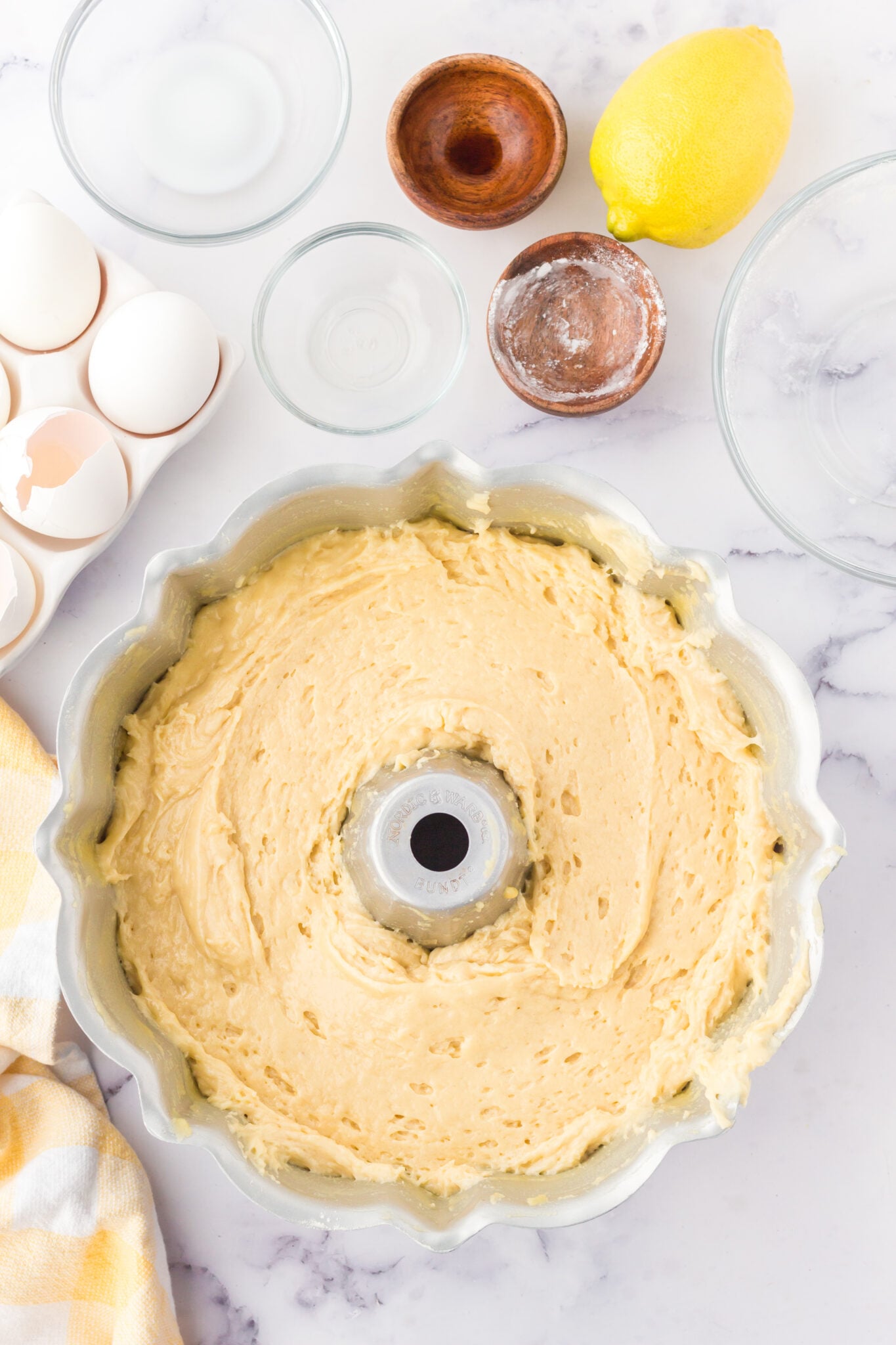 lemon cake batter in a prepared bundt pan