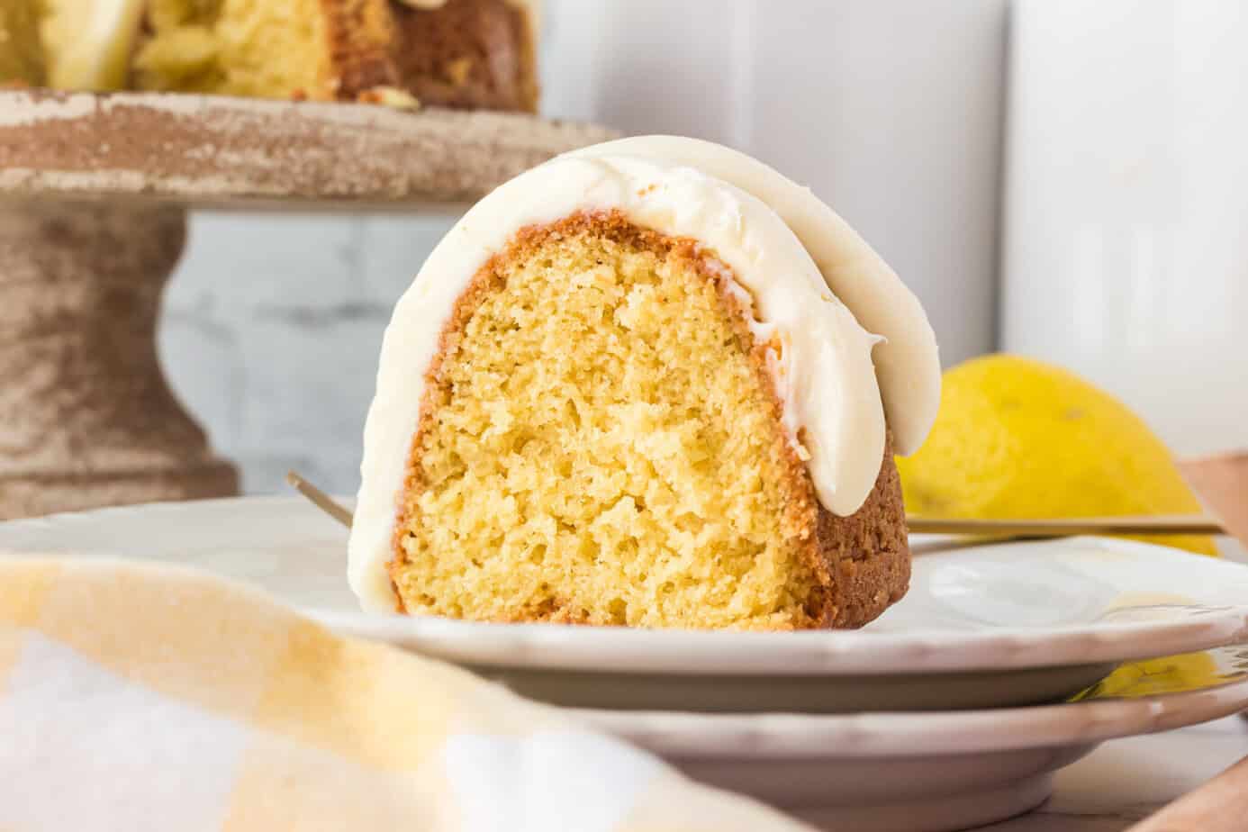 a slice of lemon bundt cake with cream cheese frosting