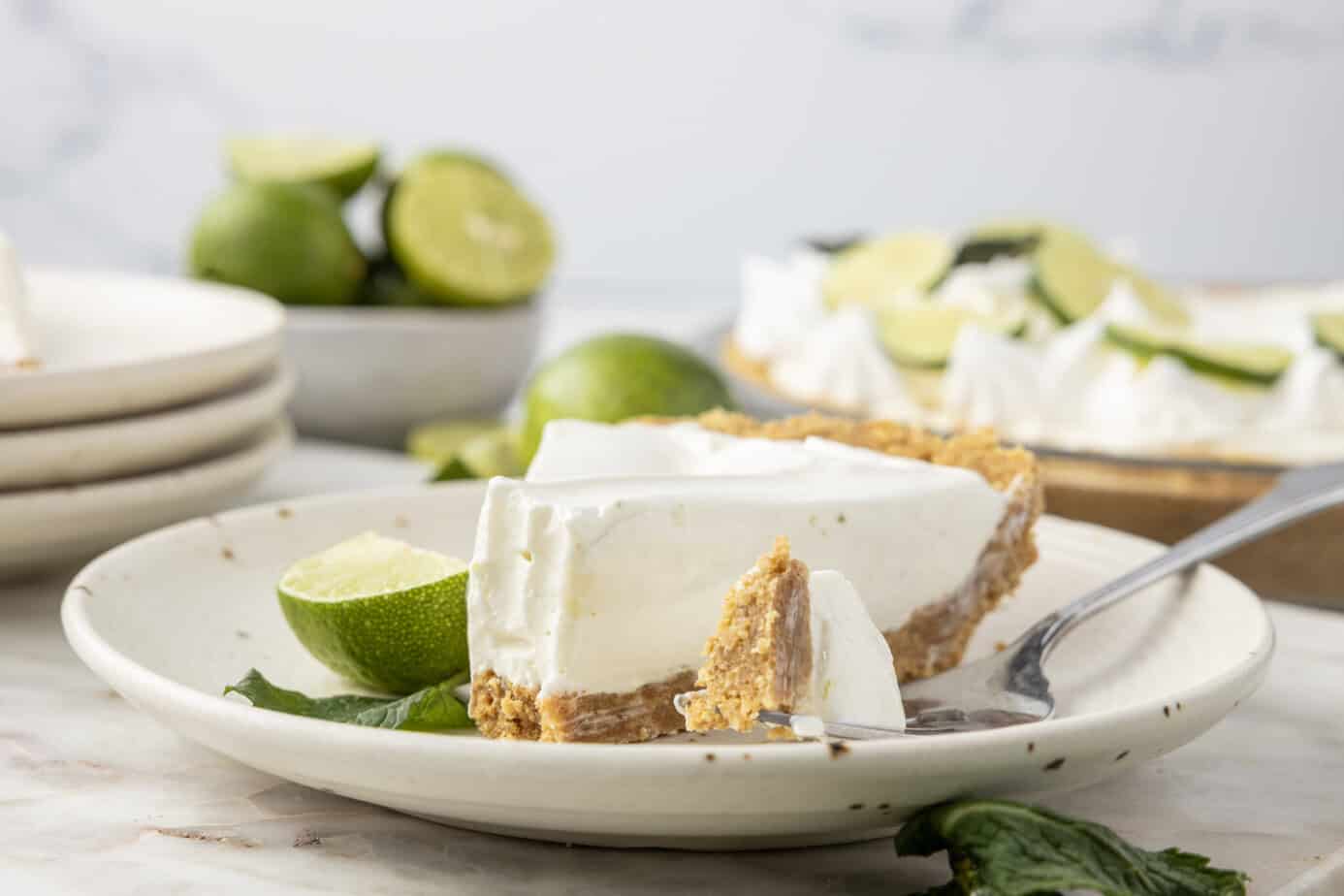 slice of key lime pie no bake with a bite missing