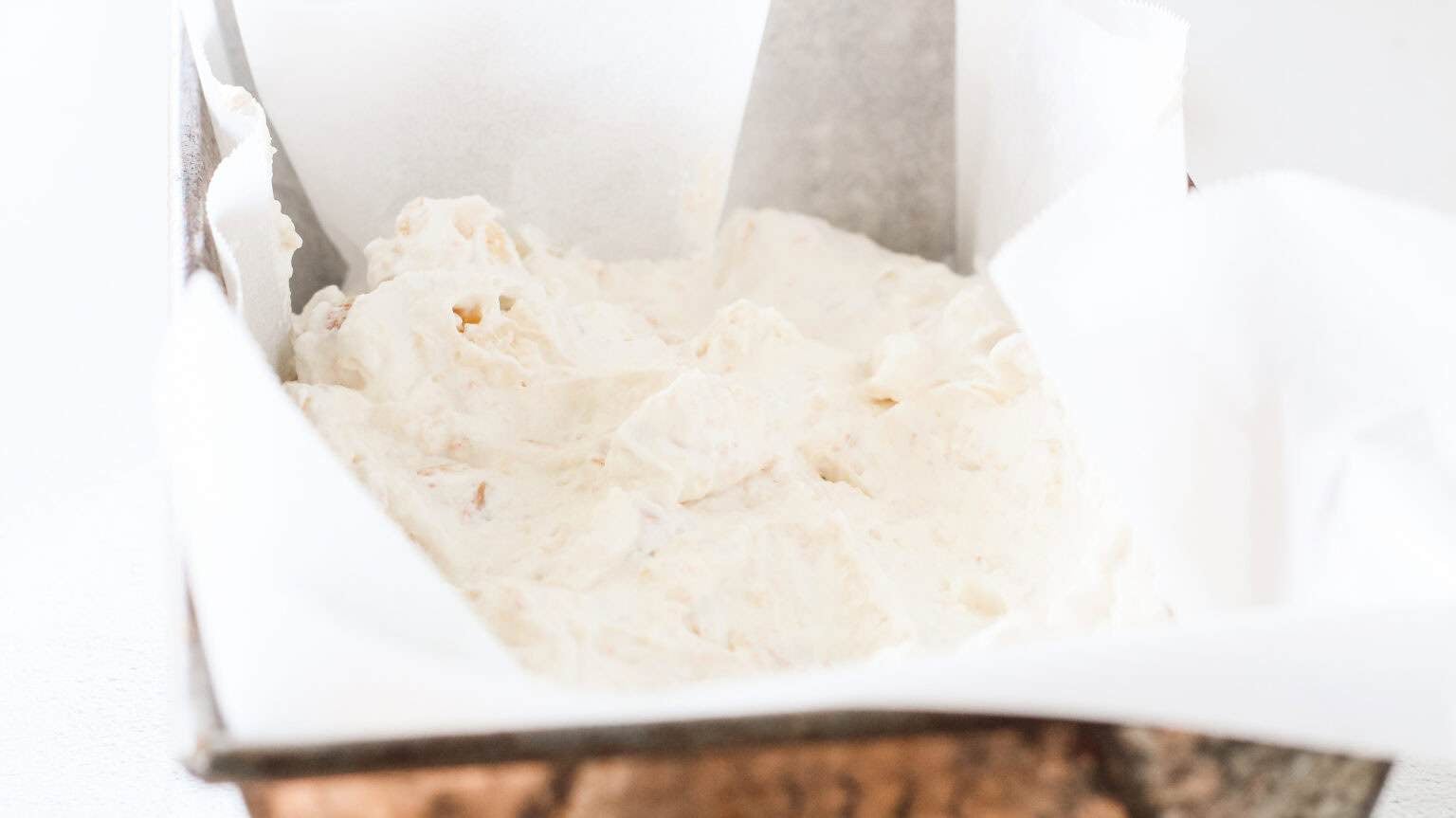 half of ice cream in parchment lined loaf pan