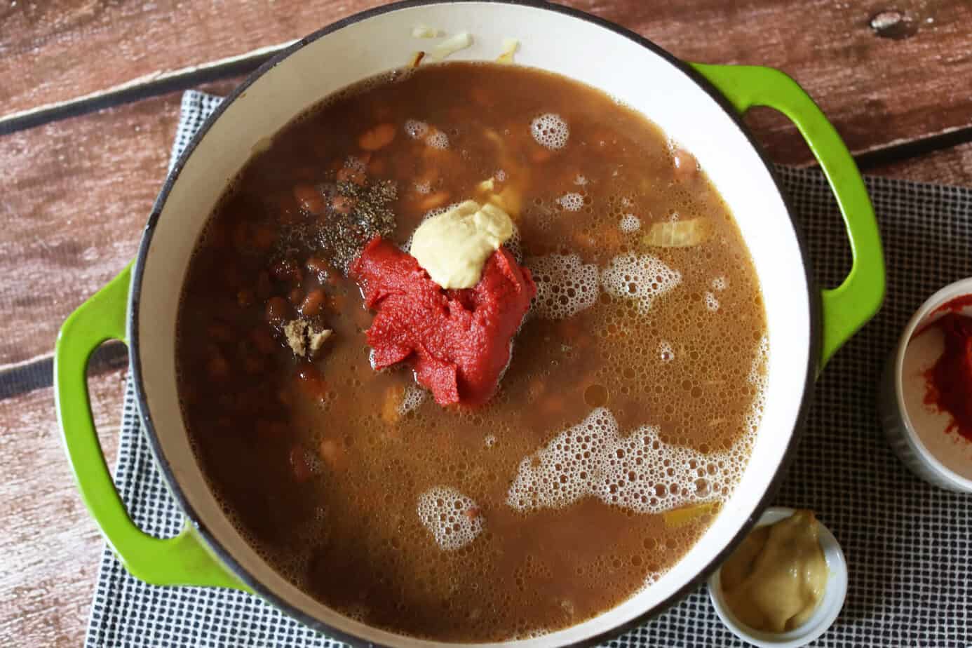 bbq ingredients added to pot of beans
