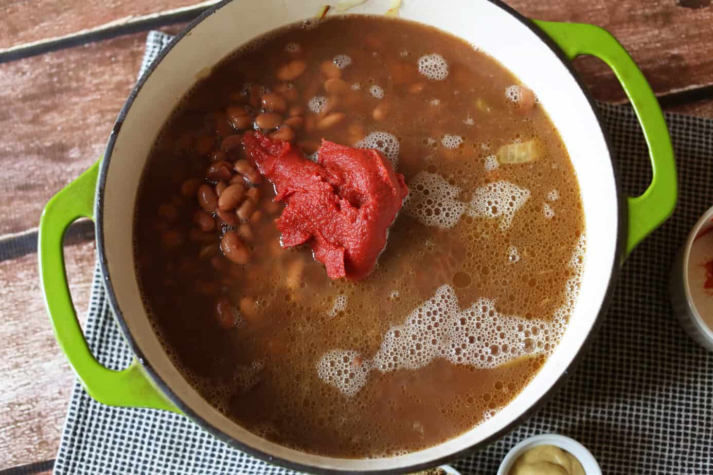bbq ingredients added to pot of beans
