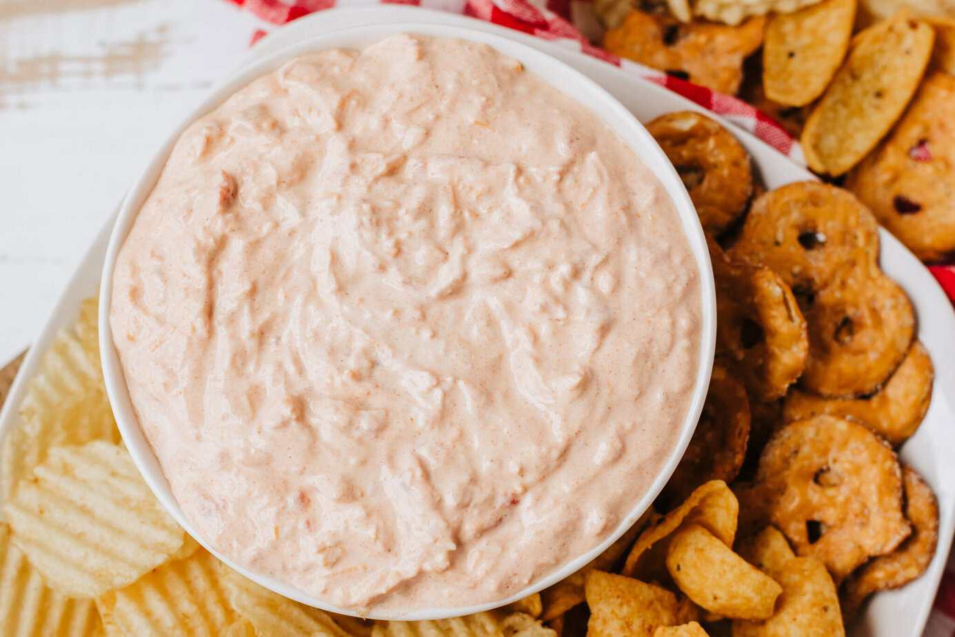 boat dip in a white bowl surrounded by chips