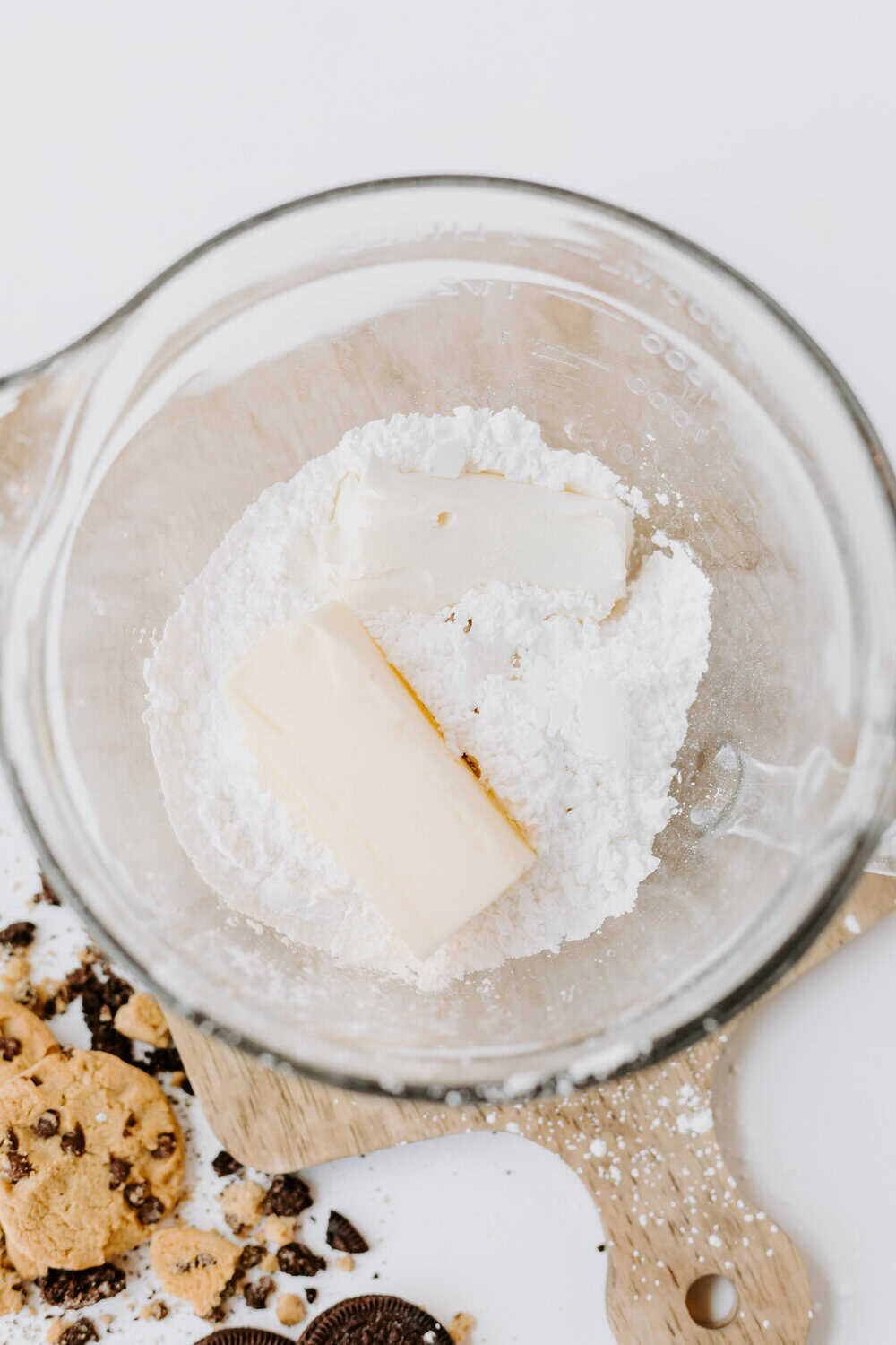 butter, cream cheese, and powdered sugar in bowl