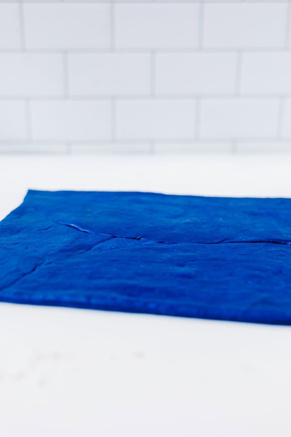 blue dough rolled out thin