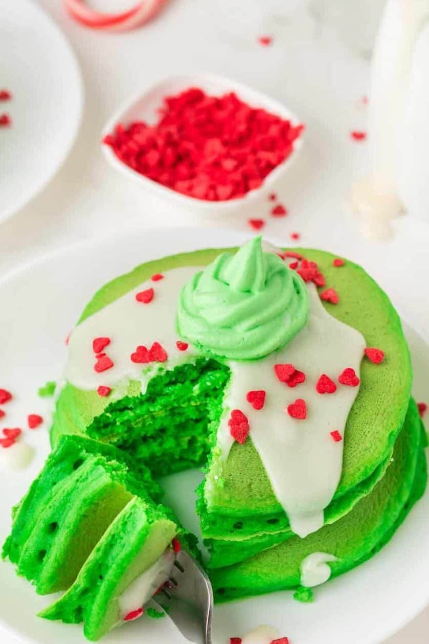 green Grinch pancakes with a wedge cut out of it