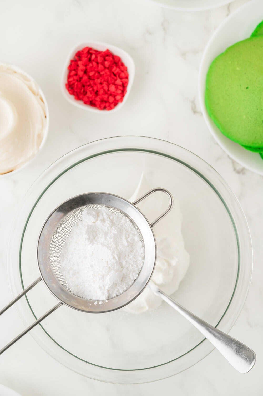 sifting powdered sugar into Cool whip